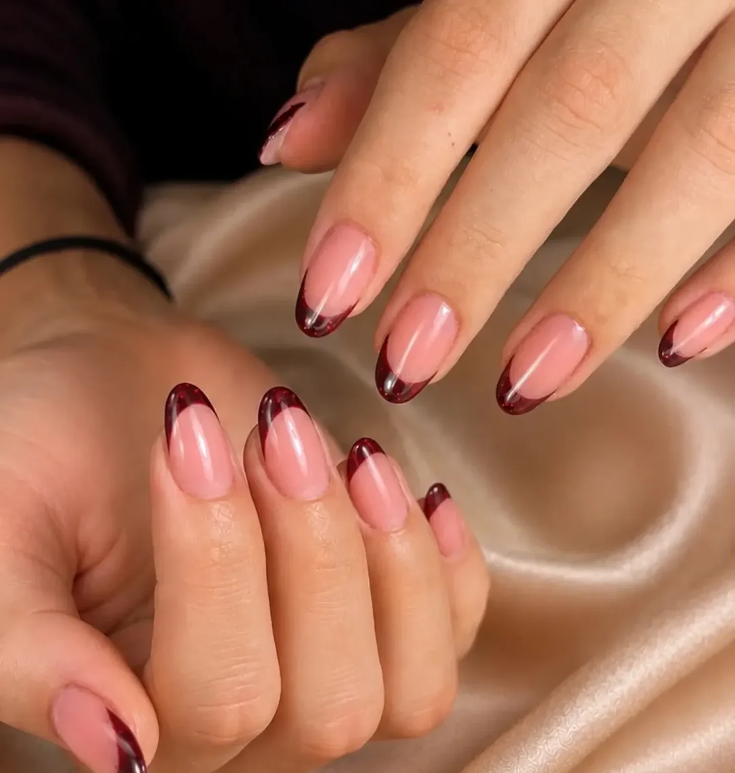 Almond nails with a deep burgundy French tip